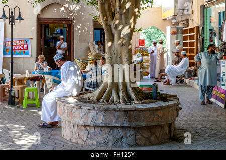 Leute sitzen im Chat auf ein Cafe In der Souk, Ad Dakhiliyah Region, Nizwa, Oman Stockfoto