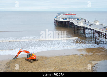 Bagger bewegen Sand neben der Pier, Cromer, Norfolk, England UK Stockfoto