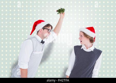 Zusammengesetztes Bild geeky Hipster mit Mistel Stockfoto