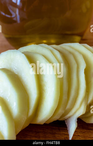 Frische Kartoffelscheiben und Olivenöl Stockfoto