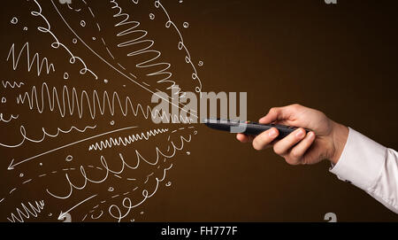 Hand mit Fernbedienung und geschweiften Linien Stockfoto