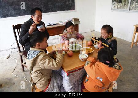 (160224)--CHONGQING, 24. Februar 2016 (Xinhua)--Grundschullehrer Tao Chaolei, 52, hat mit seinen vier Schülern, darunter eine in Klasse drei und drei Vorschulalter Kinder, zu Beginn der neuen Amtsperiode am Sujiacun Dorf von Wushan County im Südwesten China Chongqing, 24. Februar 2016 Mittagessen.   (Xinhua/Wang Zhonghu) (Dhf) Stockfoto