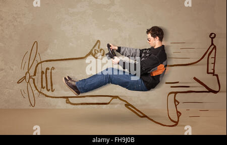 Lustige pilot Fahrt eine Hand gezeichnet Flugzeug an der Wand Stockfoto