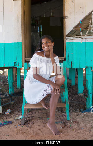 Eine junge einheimische Amazone cabocla (ribereno) Frau sitzt auf den Stufen eines Holzhauses in Marajo Insel, Belem, para Staat, brasilianischen Amazonas Stockfoto