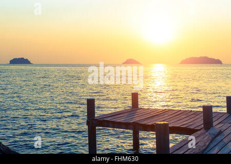 Holzsteg am Meer während des Sonnenuntergangs. Stockfoto