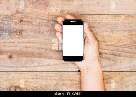 Smartphone in einem männlichen Händen auf alten hölzernen Hintergrund Stockfoto