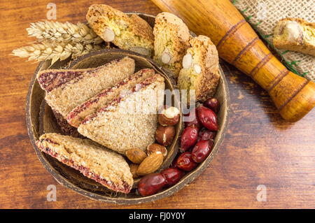 Integrale Kekse mit Mandeln und Hagebutten in einer Kokosnussschale serviert Stockfoto