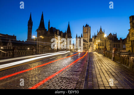 Ein Blick in Richtung St.-Nikolaus Kirche im Stadtzentrum von Gent in der Dämmerung am Morgen. Die Wege des Verkehrs können auf der Straße gesehen Stockfoto