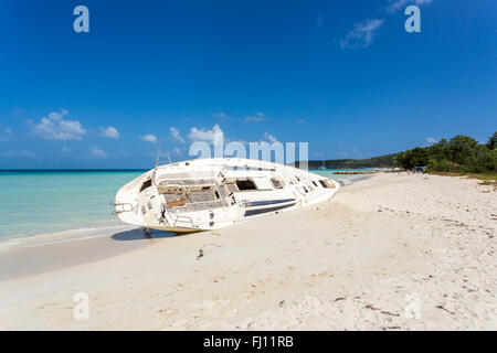 Havarierte Jacht aufgegeben am Strand in Dickenson Bay, North Antigua, Antigua und Barbuda, Westindien an einem sonnigen Tag, blauer Himmel Stockfoto