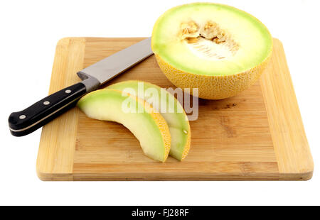 Ein Galia Melone und Messer auf ein Schneidbrett aus Holz. Stockfoto