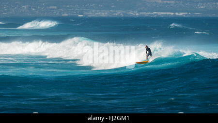 MAUI, HAWAII, USA - 10. Dezember 2013: Surfer ist eine Welle am Hookipa Beach fahren Stockfoto