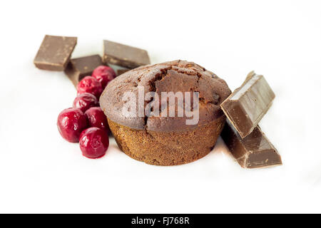 Schoko-Muffin mit Sauerkirschen isoliert auf weißem Hintergrund Stockfoto