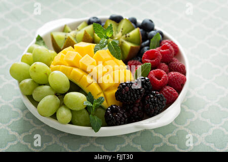 Obstteller mit Beeren, Mango und kiwi Stockfoto