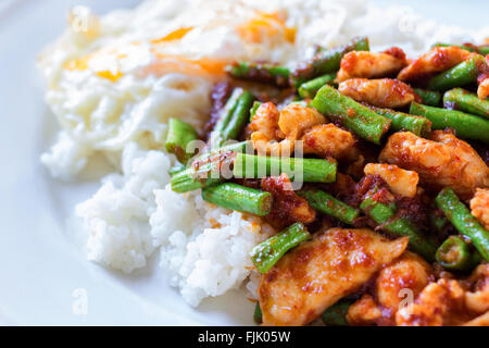 Ein Foto von rühren Brathähnchen mit roter Currypaste Hof lange Bohnen gießen Reis hinzufügen Stockfoto