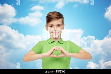 fröhlicher Junge Herzen Hand Anzeichen über blauen Himmel Stockfoto