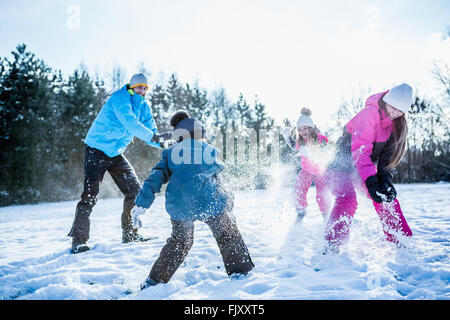 Familie spielen Schneeballschlacht Stockfoto