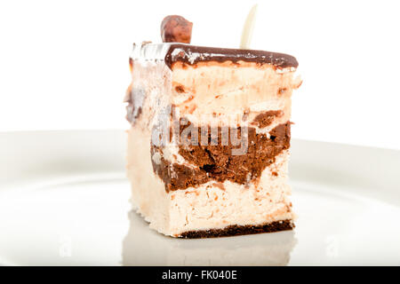 Schokoladen-Käsekuchen Isolated on White Background. Dessert Kuchen auf weißen Teller mit Schokolade. Kuchen mit Schokolade Crea Stockfoto