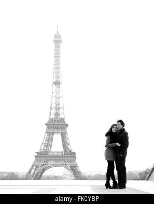 Jung und in Liebe Brünette Pärchen vor Eiffelturm, Paris, Trocadero mit Blick auf die Stadt während des Tages - umarmt Stockfoto
