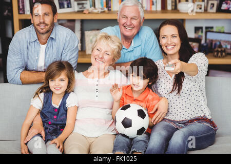 Lächelnde Familie beobachten Fußballspiel Stockfoto