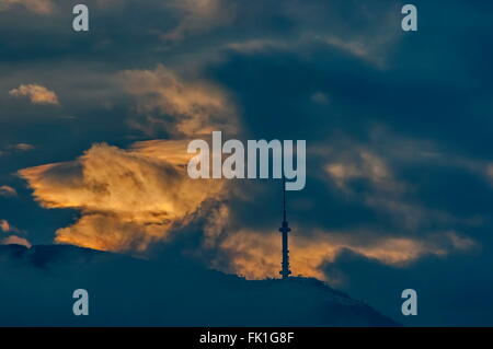 Vitosha Berg mit Fernsehturm über Sofia Stadt bei Einbruch der Dämmerung stürmischer Sonnenuntergang, Bulgarien Stockfoto
