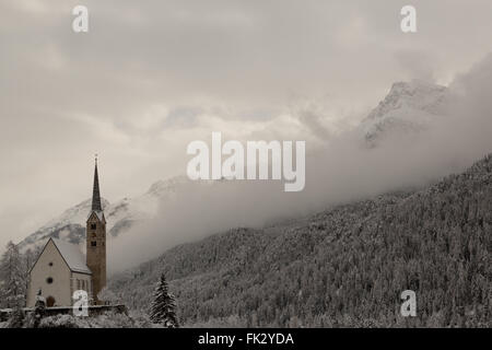 Winter hat einen späten Auftritt in der reformierten Kirche in Scuol im Kanton Graubünden, Schweiz. Stockfoto