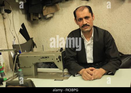 Ein kurdischer Schneider in seiner Werkstatt in Erbil Basar. Stockfoto