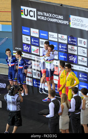 London, UK, 6. März 2016. UCI 2016 Track Cycling World Championships. Das Podium der Herren Madison vorgestellten Großbritanniens Sir Bradley Wiggins und Mark Cavendish (Zentrum, Gold), Frankreichs Morgan Kneisky und Benjamin Thomas (links, Silber) und Spaniens Sebastian Mora und Albert Torres (rechts, Bronze). Wiggins (Mitte-rechts) umarmt und hebt Cavendish (Mitte-links); Das Paar gewann zuletzt den Titel im Jahr 2008. Bildnachweis: Clive Jones/Alamy Live-Nachrichten Stockfoto