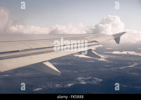 Flügel und Wolkengebilde. Wolken und Himmel wie durch Fenster von Flugzeugen zu sehen Stockfoto