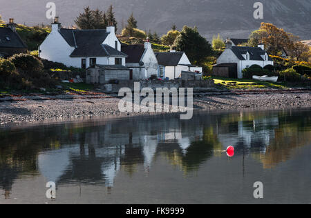 Hütten am Ardarroch spiegelt sich in Loch Kishorn Schottland Stockfoto