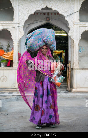 Straßenhändler, die ihre Güter auf dem Kopf, in Pushkar, Ajmer, Rajasthan, Indien, Asien Stockfoto