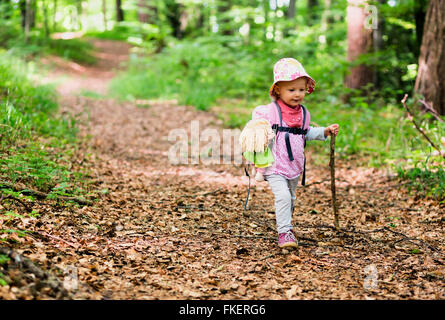 Kleinkind mit Puppe und Spazierstock, Wandern durch den Wald, Allensbach, Bodensee, Deutschland Stockfoto