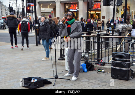 London, UK, März 2016, Dee Peacemaker Schnallen am Oxford Circus.Dee Peacemaker Afrika ist ein Edutainment-Reggae-Künstler aus Nigeria base UK. Er schreibt über soziale politische Ungerechtigkeit Afrika singt. Stockfoto