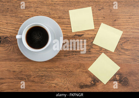 Selbstklebende Hinweis und Kaffee auf dem Schreibtisch, Aufkleber Stockfoto