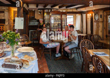 Eine Mutter mit ihren 2 Söhnen mit Tee am Nachmittag in einer Uk-Teestube Stockfoto
