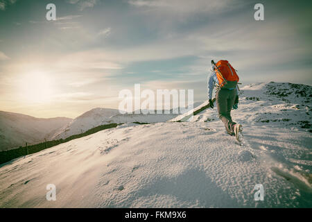 Wanderer zu Fuß über die schneebedeckten Berge im Vereinigten Königreich. Maserung und Farbe Styling angewendet Stockfoto