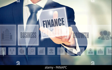 Businessman pressing an Finance concept button. Stockfoto