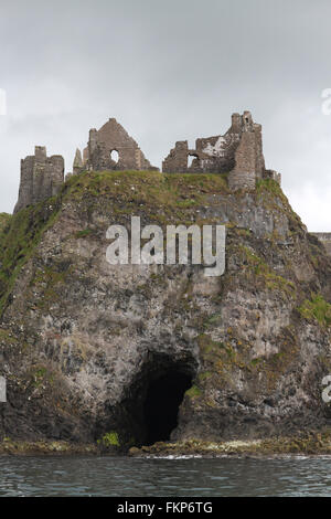 Meer Höhle unter Dunluce Castle mit Dunluce Castle vom Meer gesehen. Stockfoto