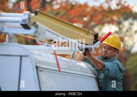 Kaukasische Arbeiter laden Leiter auf LKW Stockfoto