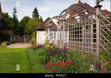 Schönen, traditionellen Garten entworfen und angelegt, Burley in Wharfedale, Yorkshire, England - Laube und blühenden Stauden Grenze im Sommer. Stockfoto