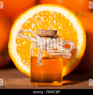 Flasche von ätherischen Ölen aus Orangen auf hölzernen Hintergrund - alternative Medizin Stockfoto