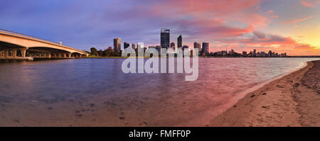 Rosa Stunde des Sonnenaufgangs über Stadt Perth CBD. Blick über den Swan River vom Sandstrand entfernt in Richtung Innenstadt mit der Brücke. Stockfoto