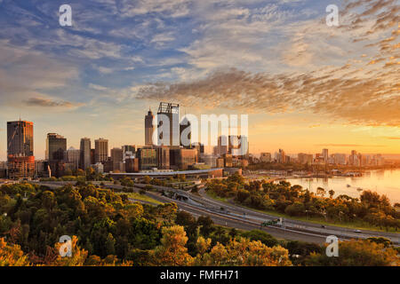 Goldene Sonne Licht Litting CBD von Perth Stadt wie vom Kings Park mit grünen Bäumen und Autobahn in die Stadt zu sehen. Stockfoto