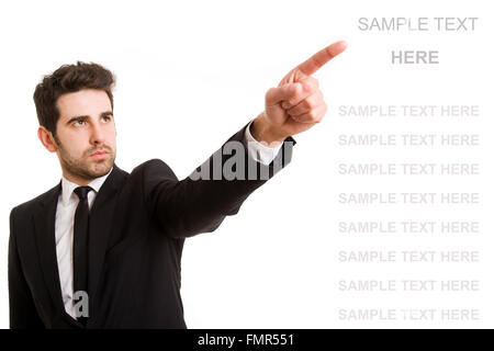 Junger Geschäftsmann zeigte auf etwas Interessantes auf weißem Hintergrund Stockfoto