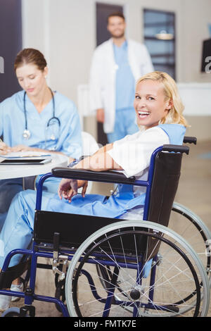 Porträt von fröhlichen Ärztin sitzt im Rollstuhl Stockfoto
