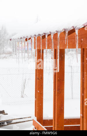 Eiszapfen hängen vom Dach des Pavillon auf dem Lande Stockfoto
