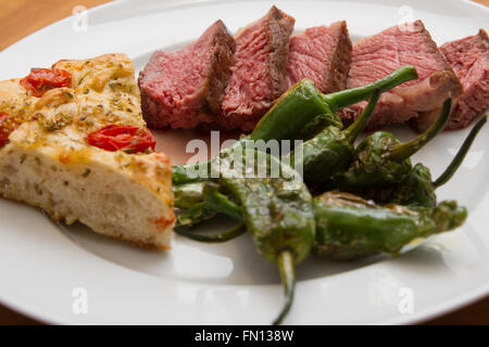 Steak mit Pimentos de Padron und Focaccia-Brot Stockfoto