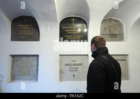 Der russische Historiker Konstantin Gerbeev untersucht die Grabstätte von Karel Kramar, dem ersten Premierminister der Tschechoslowakei, in der unterirdischen Krypta der Dormitionskirche auf dem Olsany-Friedhof in Prag, Tschechien. Karel Kramar, geboren am 17. Dezember 1860, war tschechischer (böhmischer) Politiker und der erste Premierminister der Tschechoslowakei von November 1918 bis Juli 1919. Er starb am 26. Mai 1937 im Alter von 76 Jahren und wurde neben seiner russischen Frau Nadezhda Kramar begraben, die fünf Monate zuvor im Alter von 73 Jahren starb. Das Grab des russischen Kunsthistorikers Nikodim Kondakov ist links zu sehen. Stockfoto