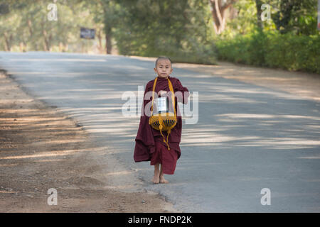 Ein junger Mönch auf seiner Morgen Almosen rund, Bagan, Myanmar Stockfoto