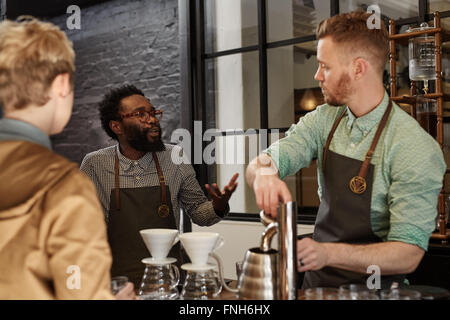 Manager erklären, etwas an einen Mitarbeiter im Coffee-shop Stockfoto
