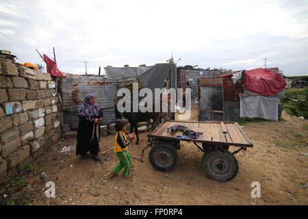 (160317)--GAZA, 17. März 2016 (Xinhua)--palästinensischen Jihan Moussa Abu Mohsen, 48, und ihr Sohn Ahmad, 10, bereiten Sie sich auf Felsen in den südlichen Gazastreifen Stadt von Khan Yunis, am 17. März 2016 zu sammeln. Jihan, der von den Morgenstunden bis spät am Tag arbeitet, verkauft einen Wagen voller Ziegel Stein Hersteller für 4 US-Dollar pro Tag. Ihre Arbeit ist die wichtigste Einnahmequelle für ihre Familie, die von ihrem Mann und vier Kindern besteht. Jihan und ihr Sohn Ahmad aufstehen jeden Morgen früh, Ziegeln und Steinen von überall zu sammeln, finden sie sie, ob in Deponien, Straßen oder Wegrändern. (Xinhua/Kha Stockfoto